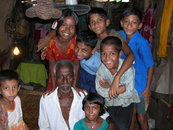 the man and many small children are posing for a picture