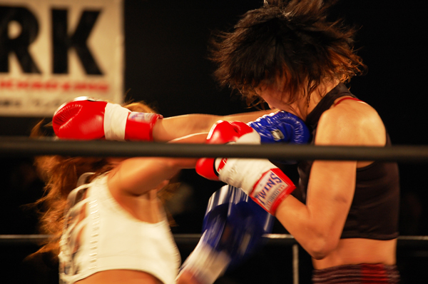 a woman punches an opponent with her hand