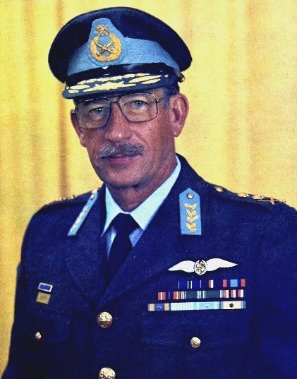 a person in uniform and glasses is posing