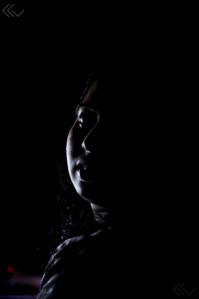 the silhouette of a young woman with her eyes closed