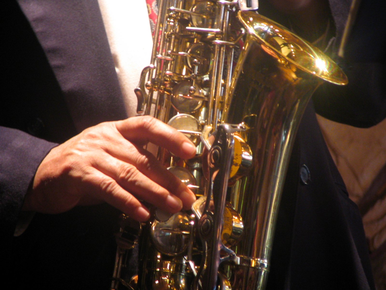 a person in a suit holding a saxophone