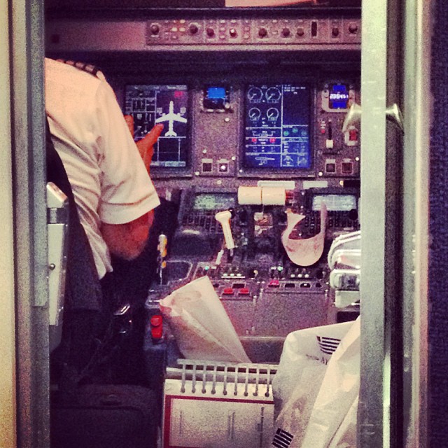 a person in the cockpit of a plane that is sitting on a desk
