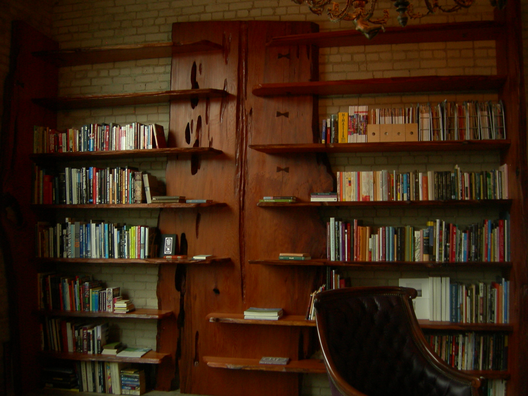 a chair that is sitting in front of a book case