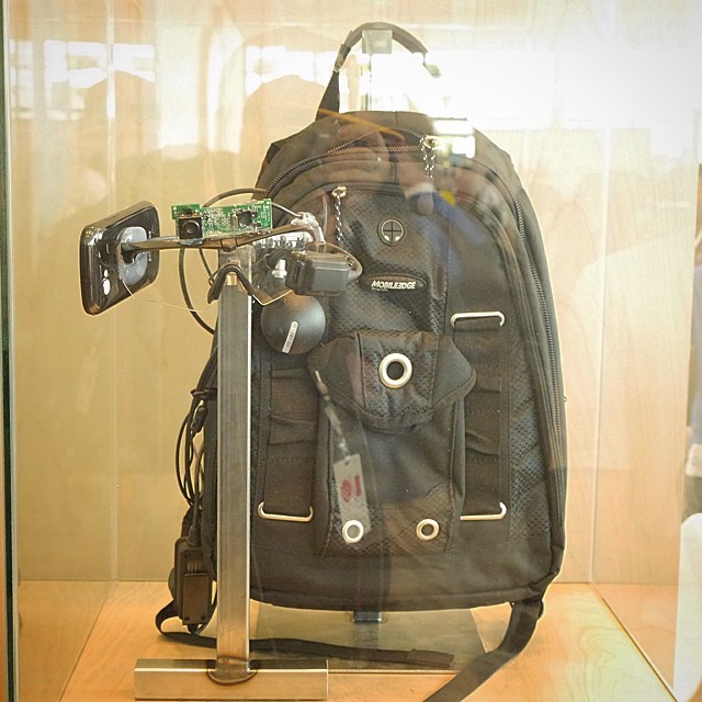 a black backpack with a camera attached to it