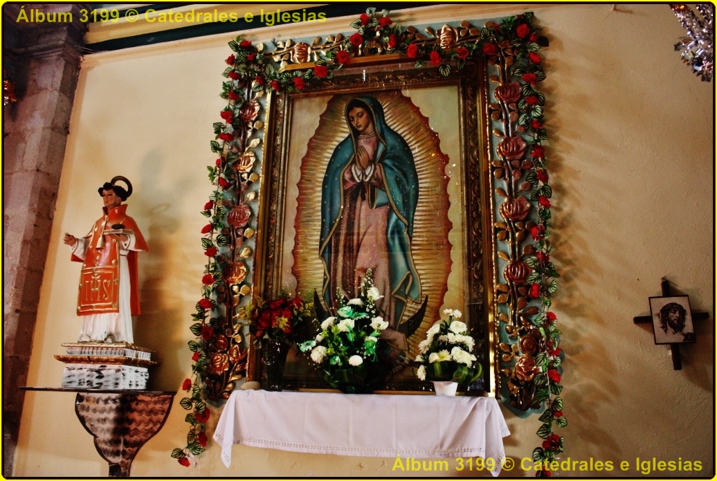 a wall with a cross and a religious painting