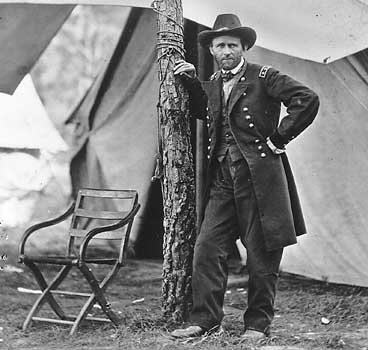 this old picture shows a man leaning on a pole