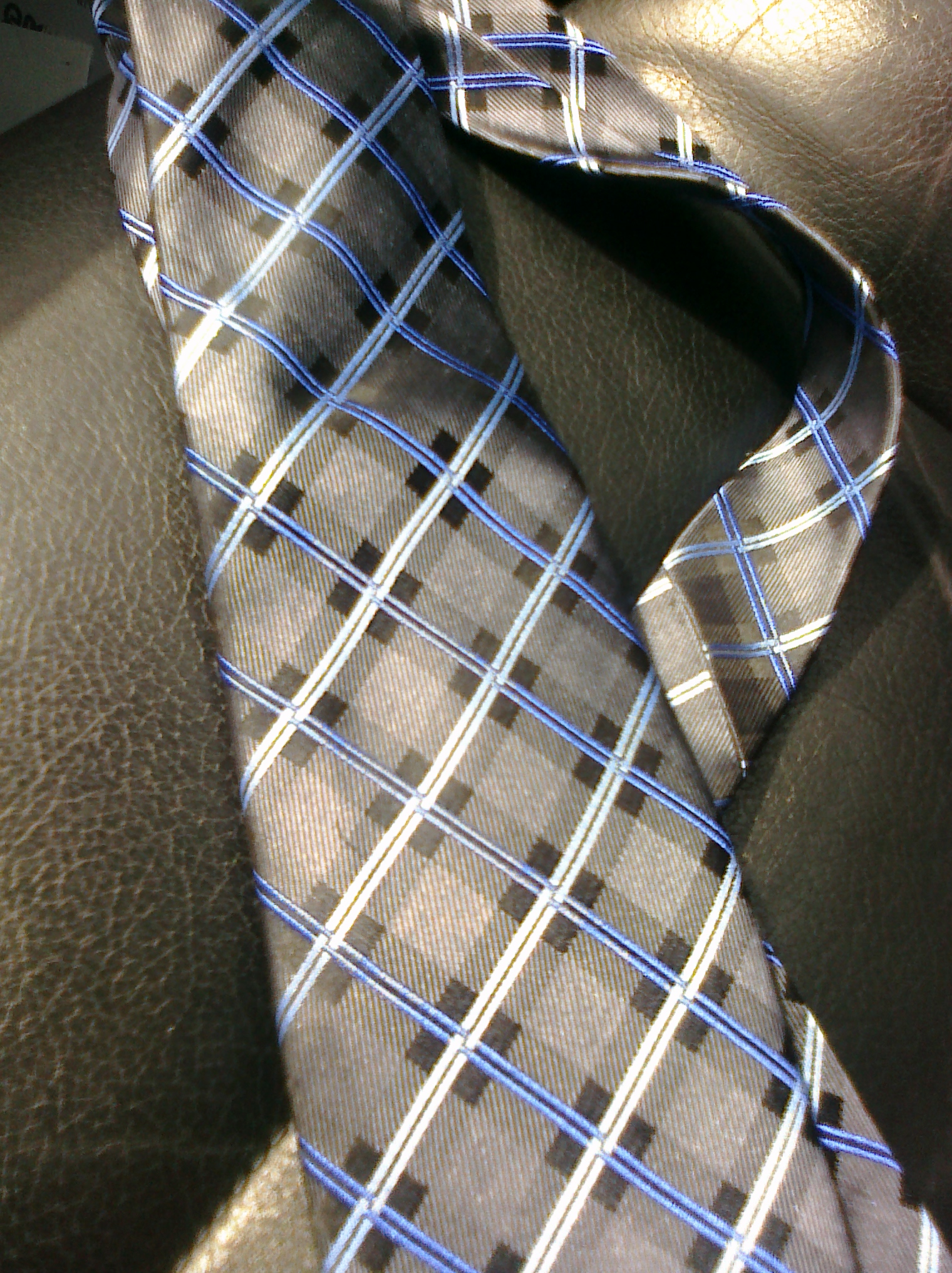 a close up of a blue and gray checkered tie