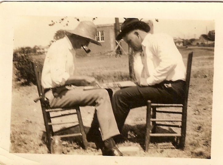 an old black and white po shows two men sitting in chairs facing one another