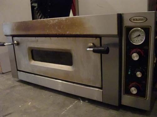 a large oven sits on a concrete floor