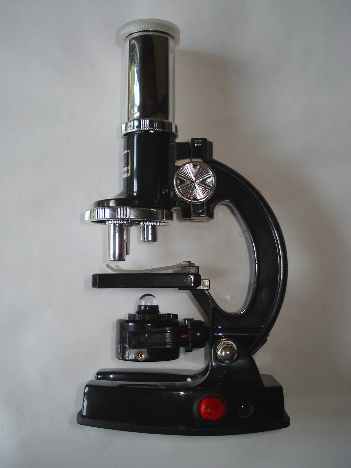 a microscope and other tools sit on a white surface