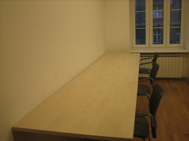 chairs and a table with wood floor in front of a window