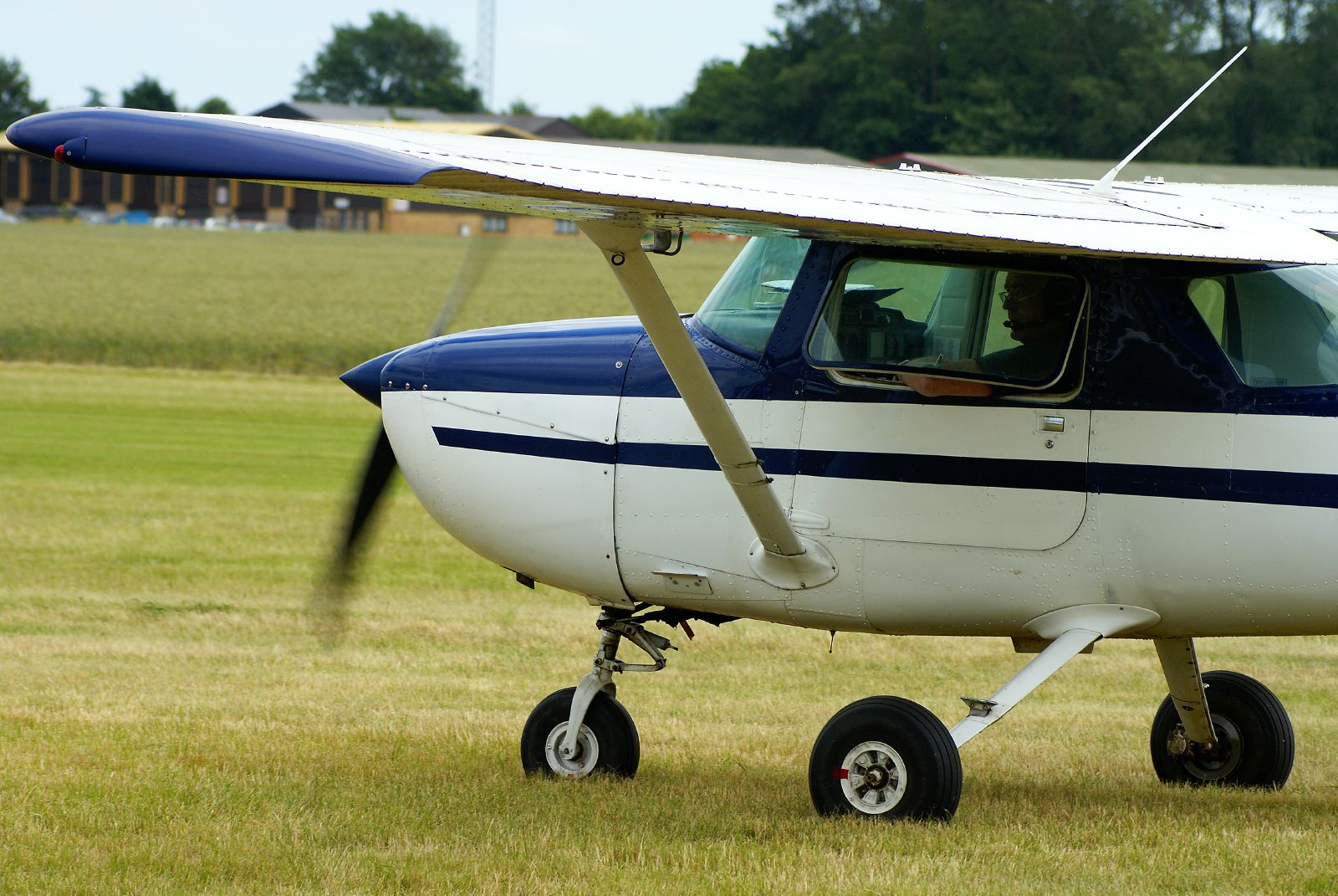 a small airplane on some grass with no wheels