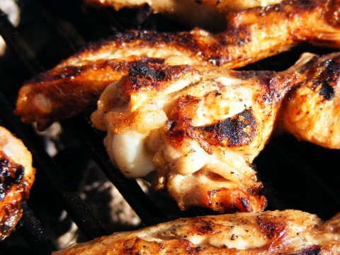 chicken and cauliflower cooking on a grill
