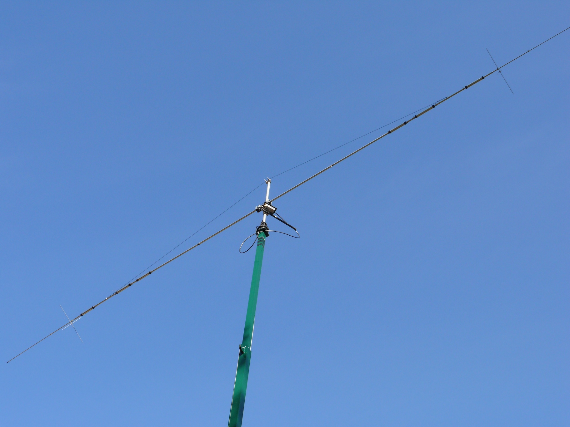 a tower that has two wires and a satellite