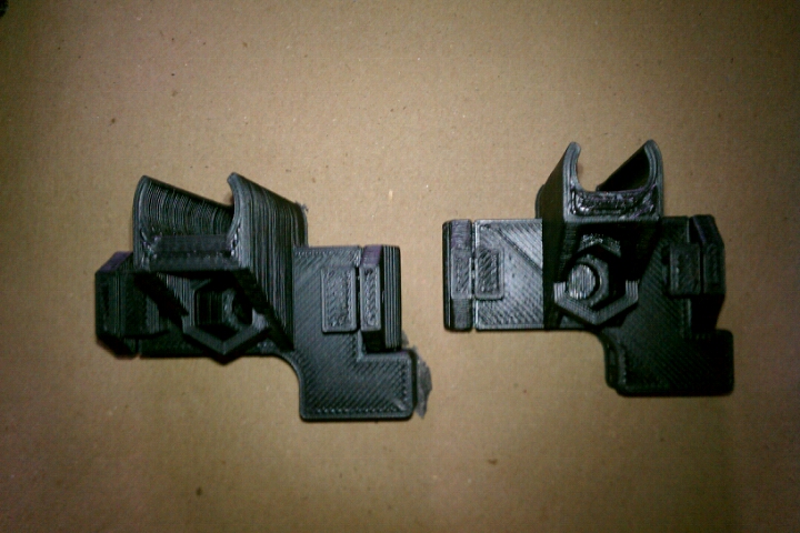 a pair of black buckles that are on a brown surface