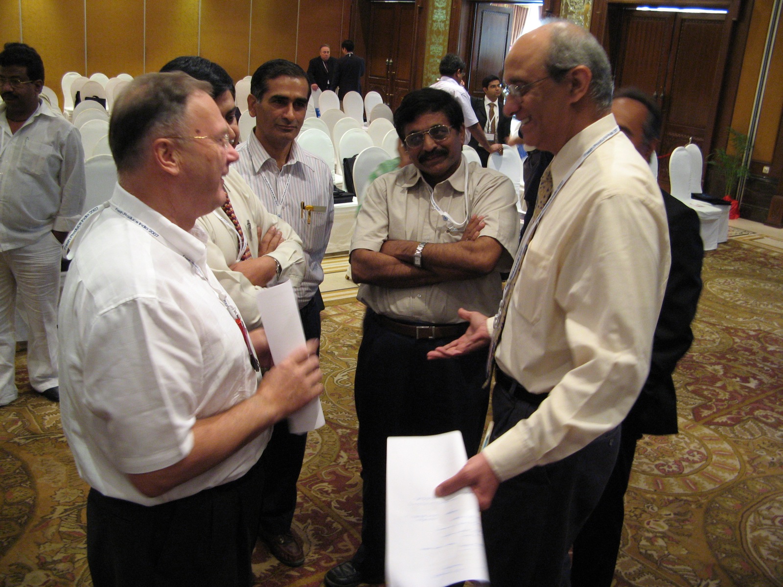 men are in formal attire standing and talking