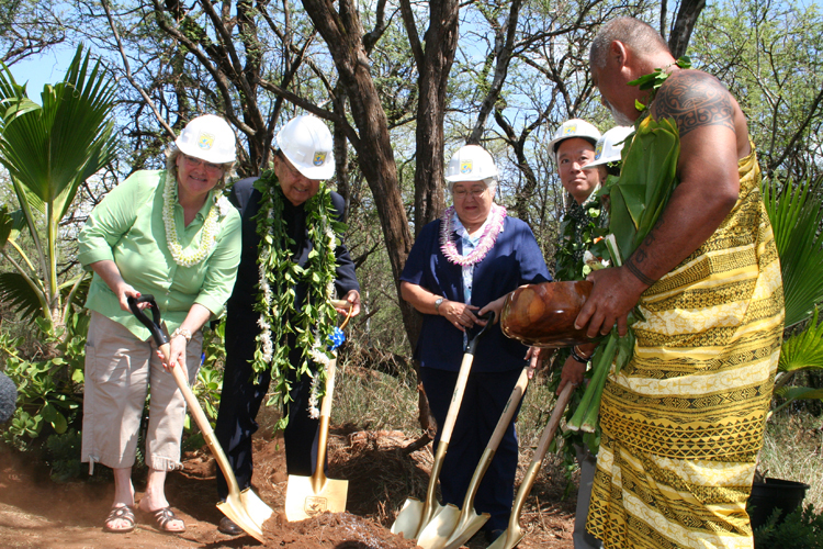 a group of people standing around each other with shovels