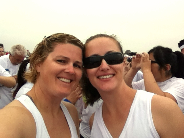 two women are posing for a po in white shirts