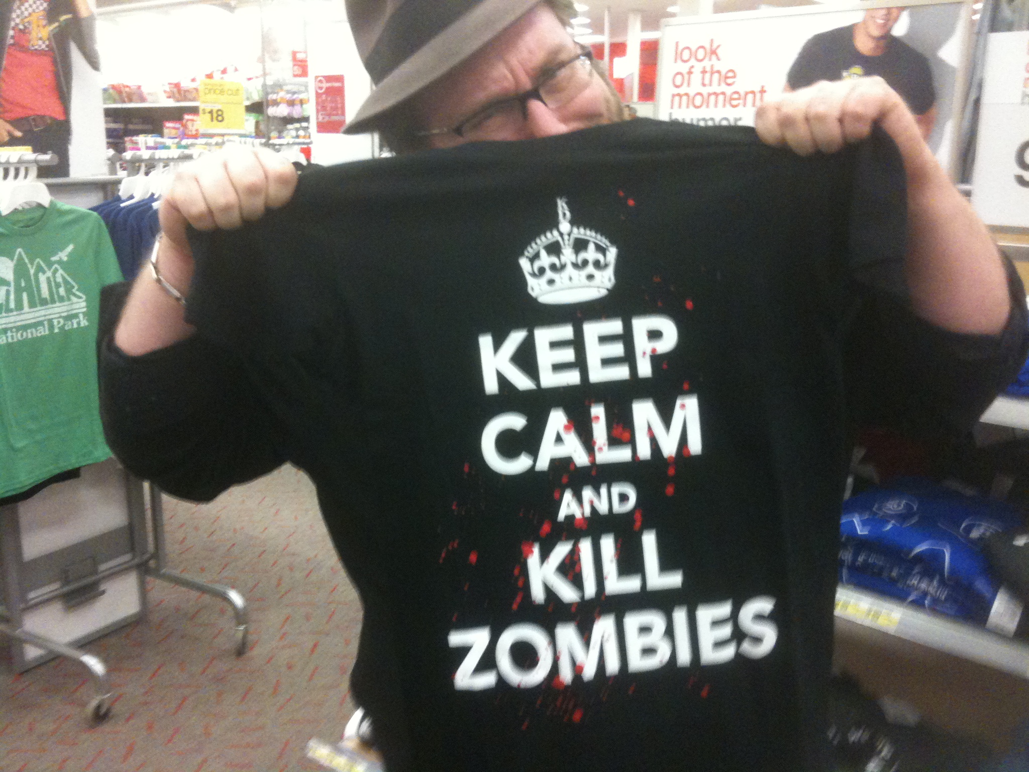 a person with a shirt that reads keep calm and  zombies