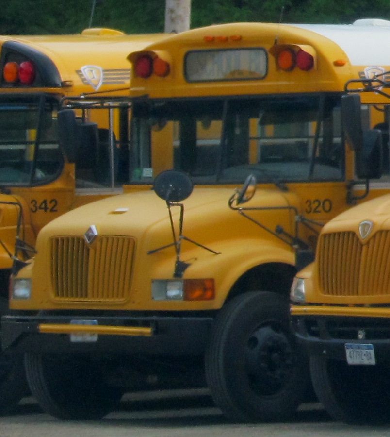 several yellow school buses lined up in a line