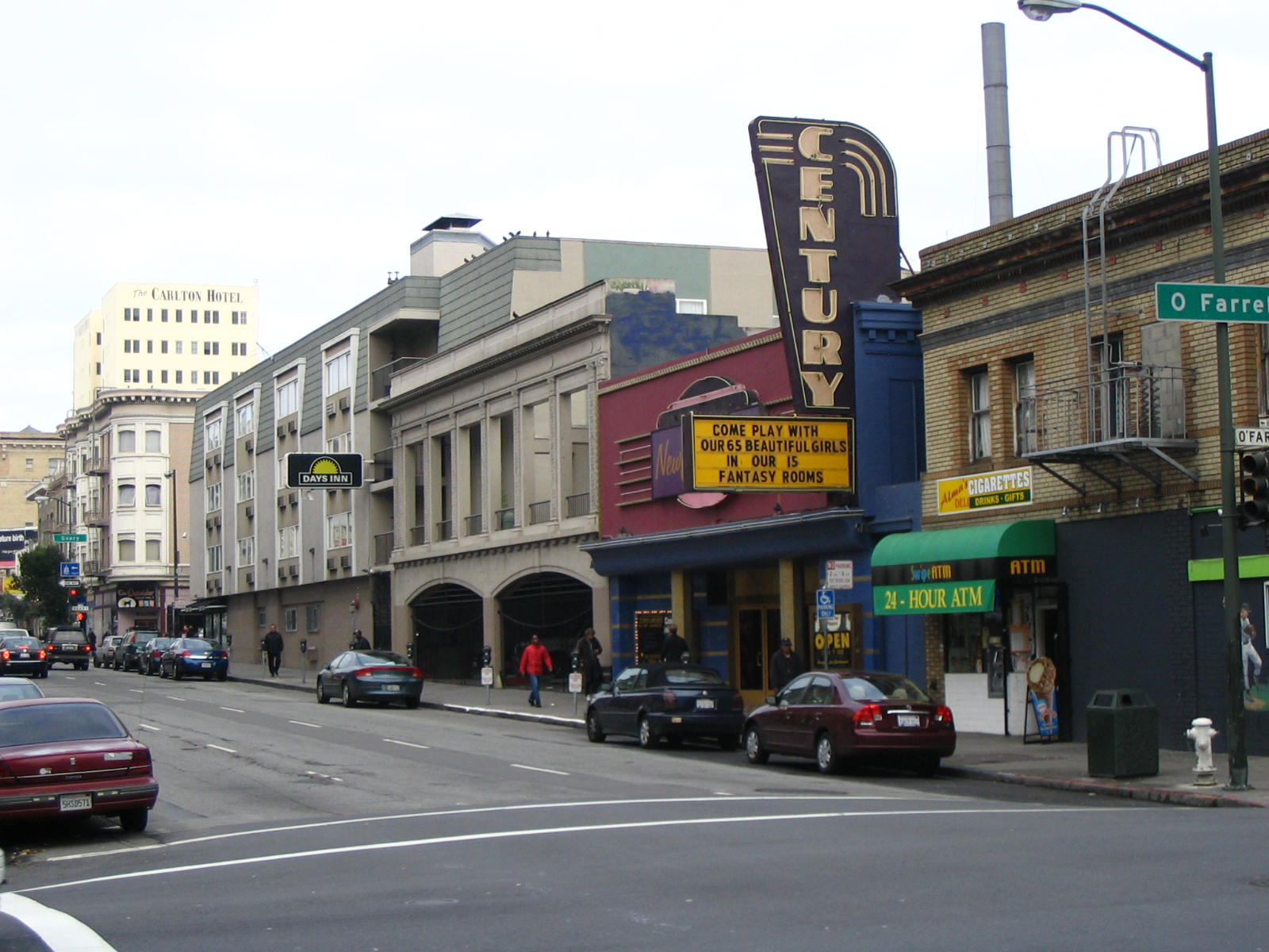 a street in the city, where people are walking and cars