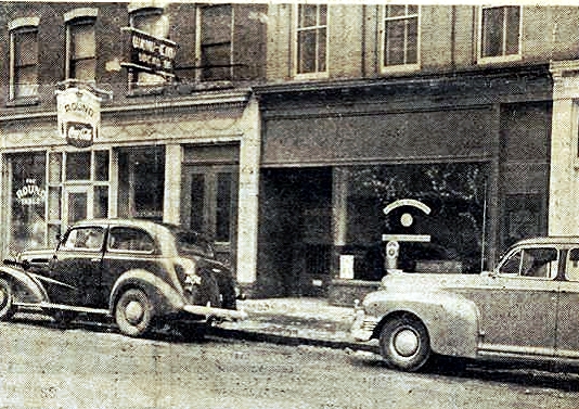 a street scene with cars pulling on to a tow truck