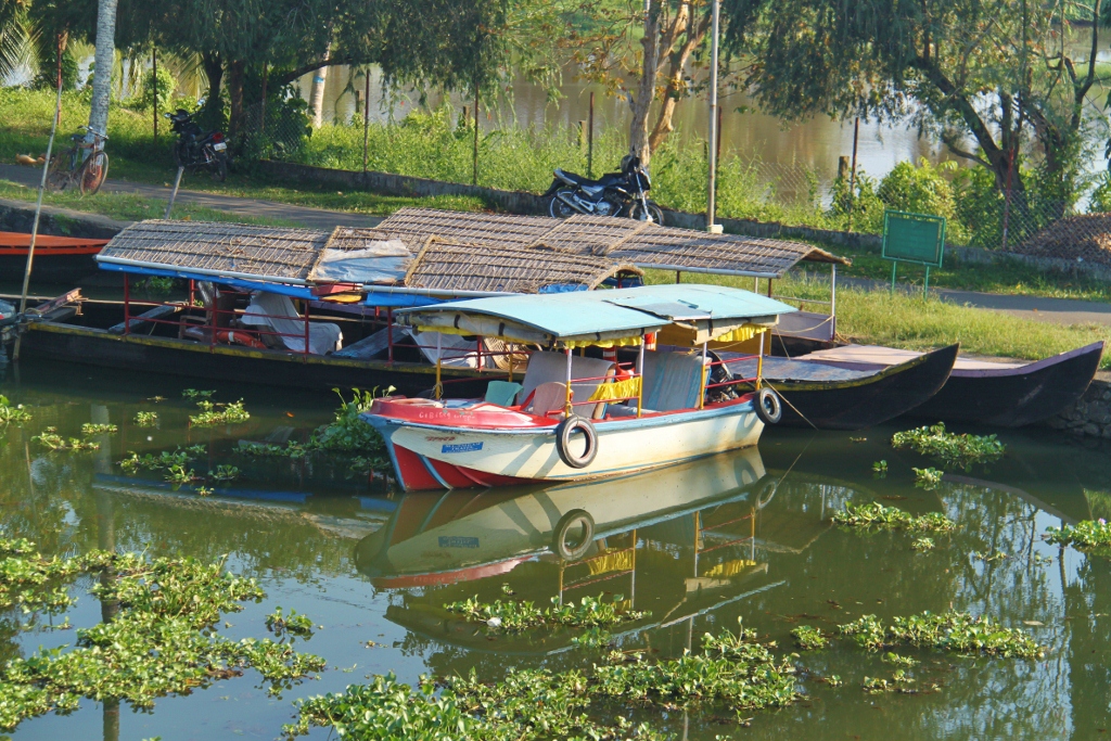 a motorboat and a boat are sitting at the end of a dock