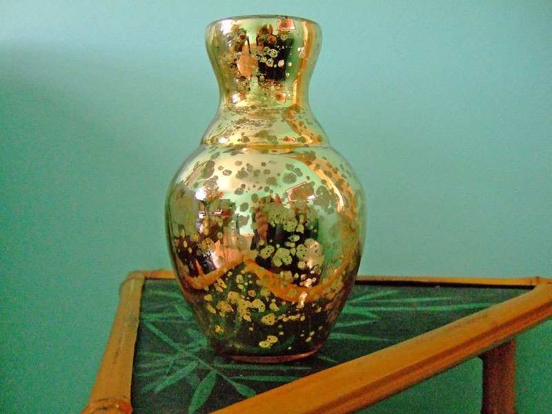 a shiny glass vase sitting on top of a table