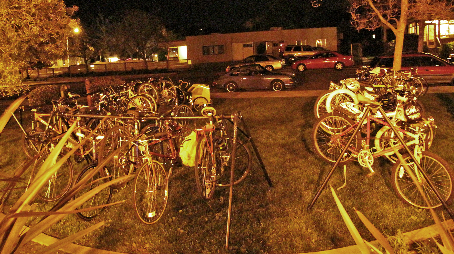 many bicycles parked side by side in a driveway