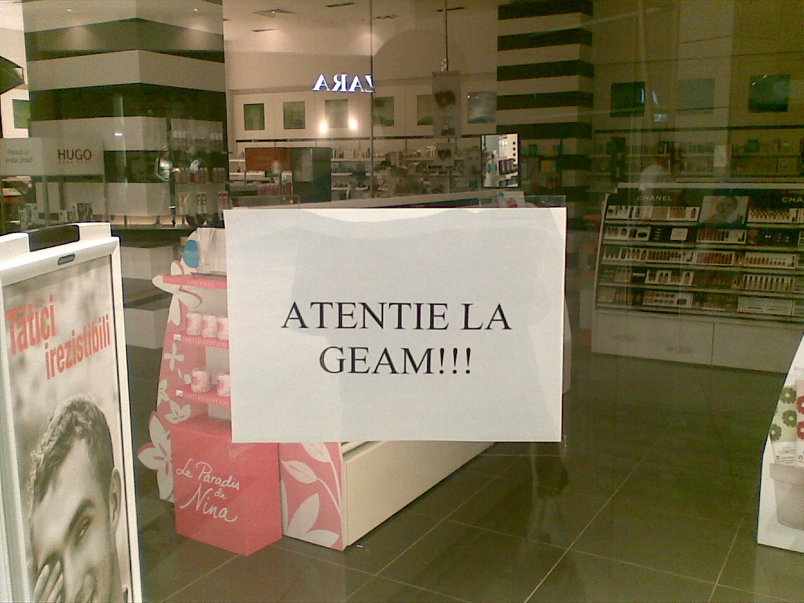 a display case with an ad for perfume