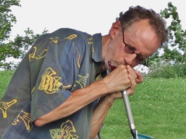 an older man leans down to sniff his mouth