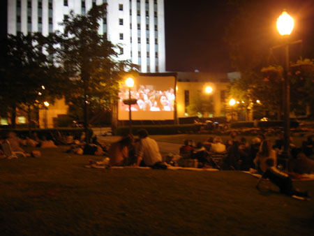 a movie sitting on the lawn in front of a building