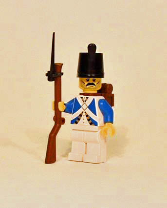 a lego man holding a rifle in his hand