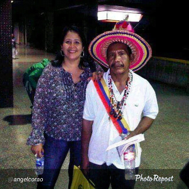 a woman standing next to a man with a sombrero