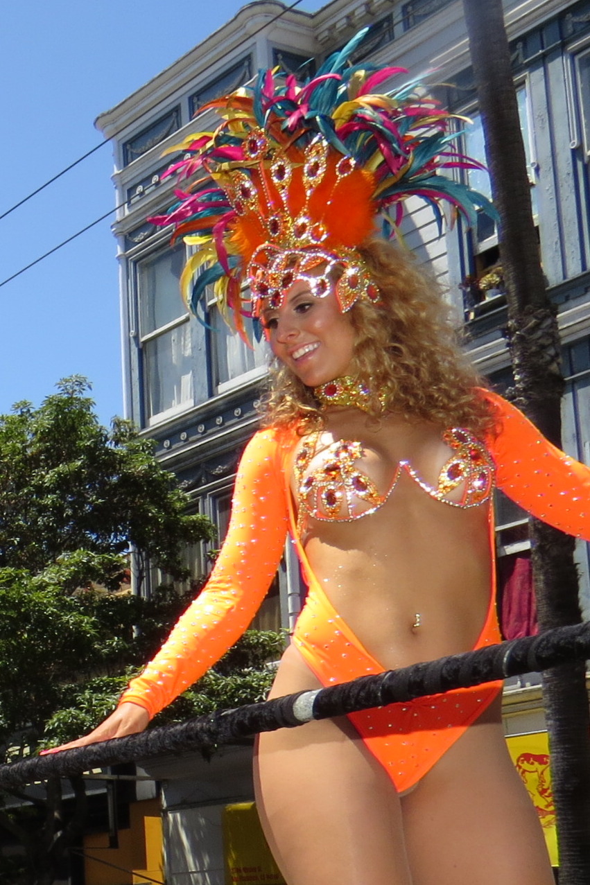a woman in orange bikini with mask and jewelry