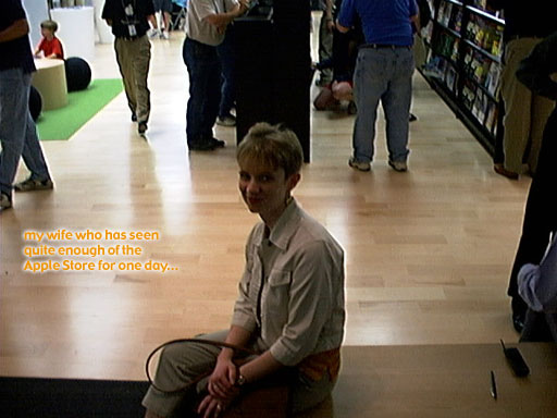 a man is sitting down on the ground in a book store