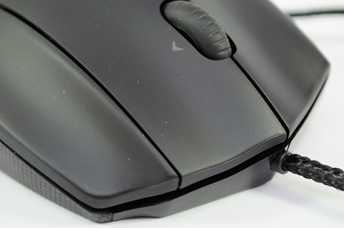 a computer mouse with a black cord on top of it