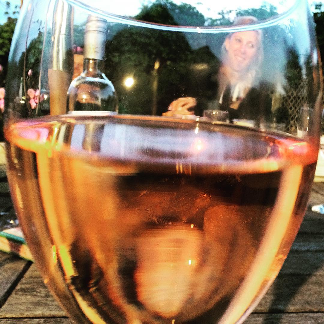 a close up of a wine glass filled with liquid