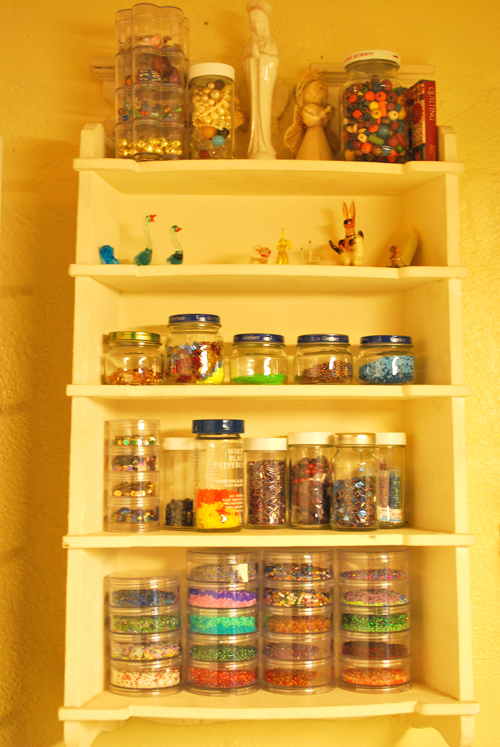 a shelf with several containers that hold small toys and toys