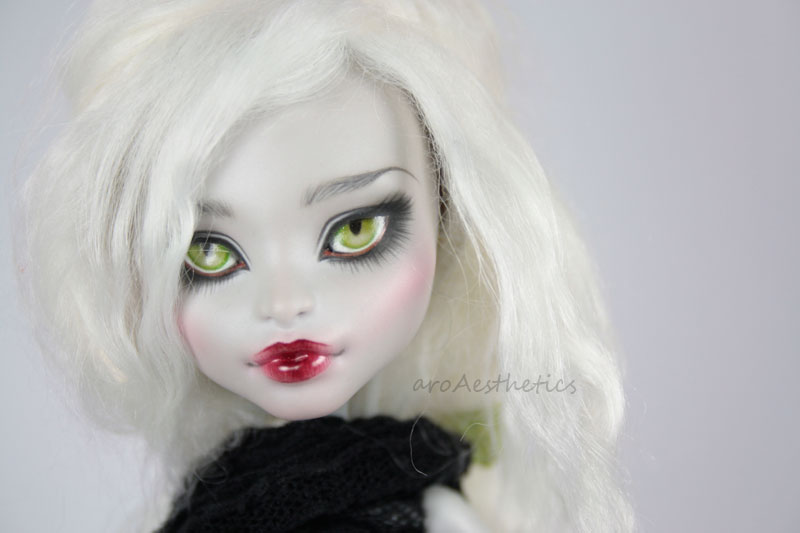 a doll with black lips and white hair is dressed in a dark dress