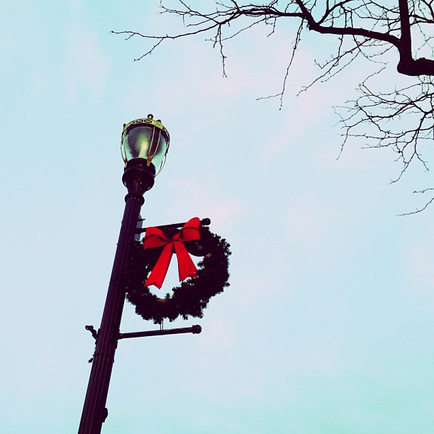 the wreath is on top of the light pole