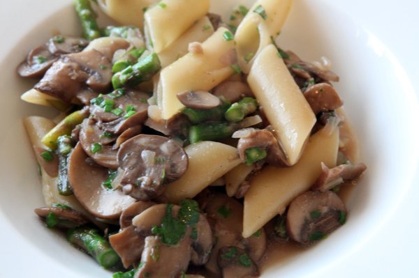 mushroom and pea salad in a white bowl