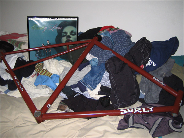a bike frame with multiple shirts in front of it