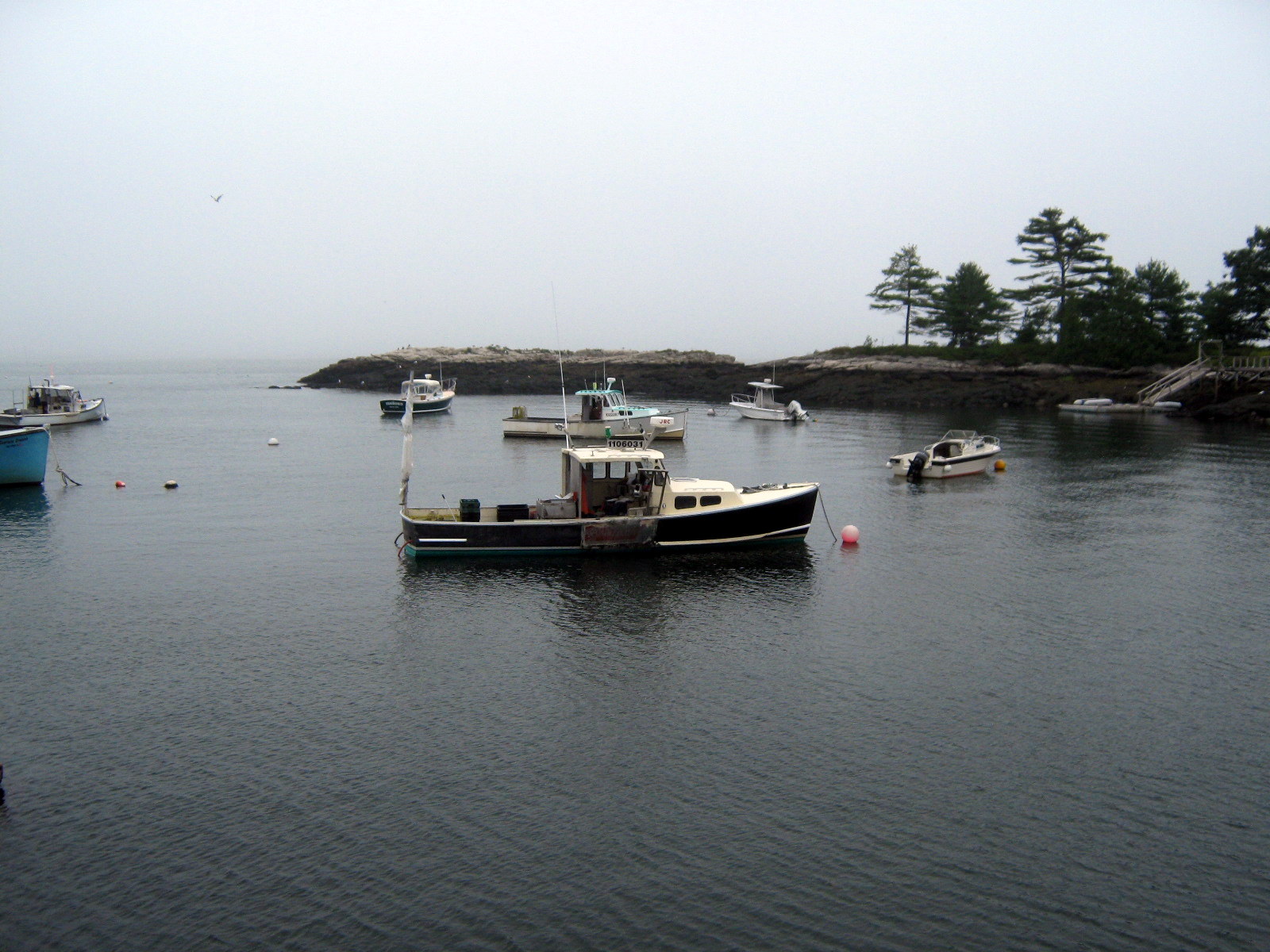 three boats on a body of water near a island