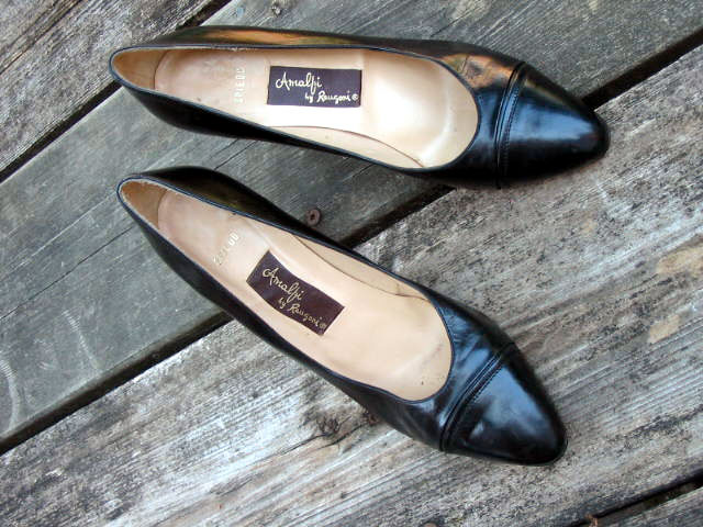 black leather heels with a label on the side