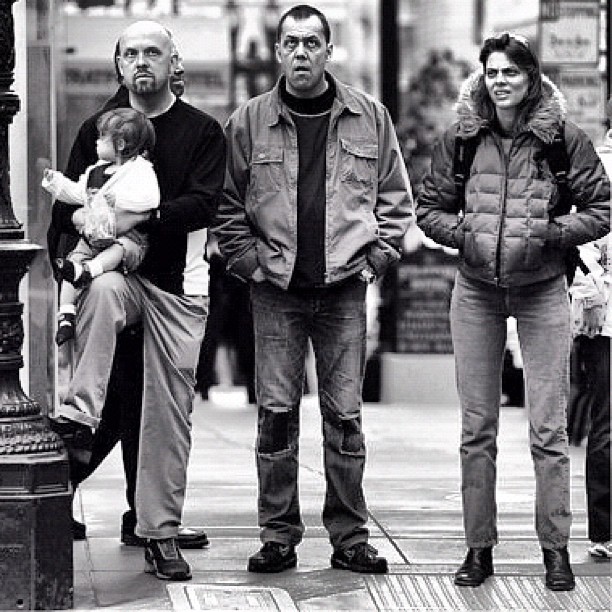 a man and several people walking down a street