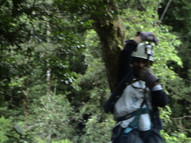 man with backpack walking through the woods carrying soing