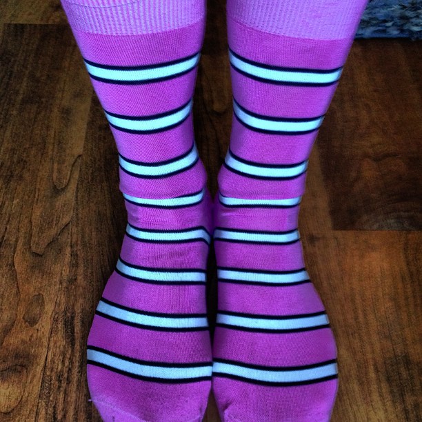 a person in striped socks standing on the floor