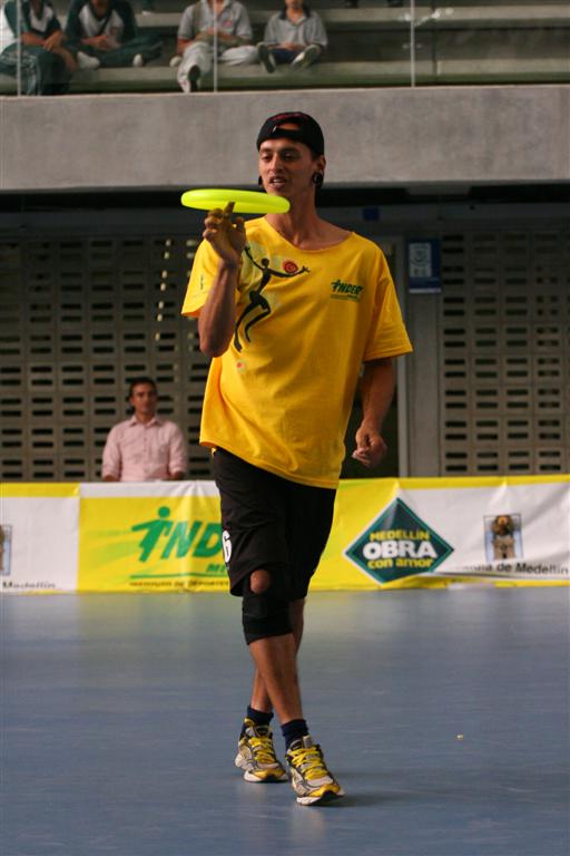 a person that is playing in a court with a frisbee
