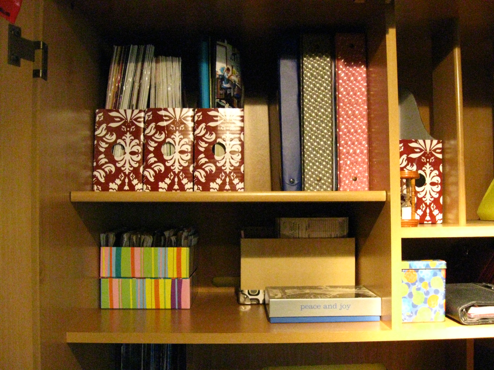a shelf with books, folders and file cards